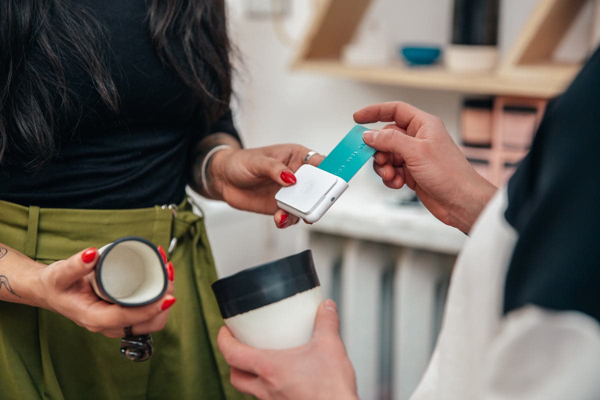 Retail transaction being processed with a card reader at checkout.