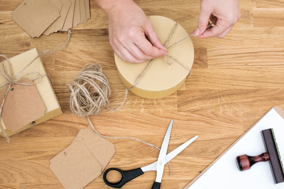 Team members packing and labeling products on a fulfillment table.