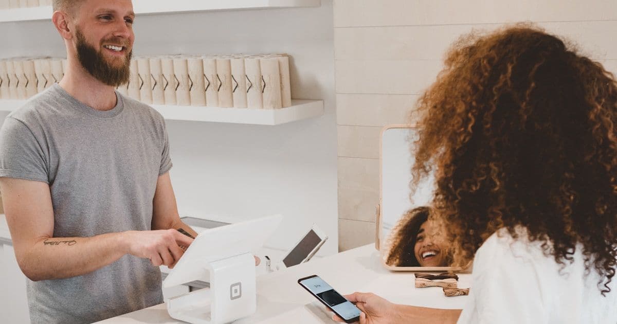 A retail associate processing a return at a store POS terminal