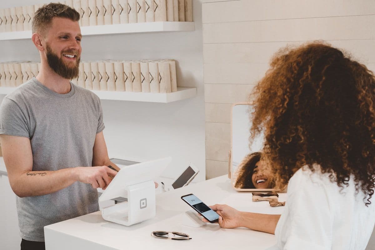 Retail store counter with POS terminal and receipt printer, representing storefront payment operations
