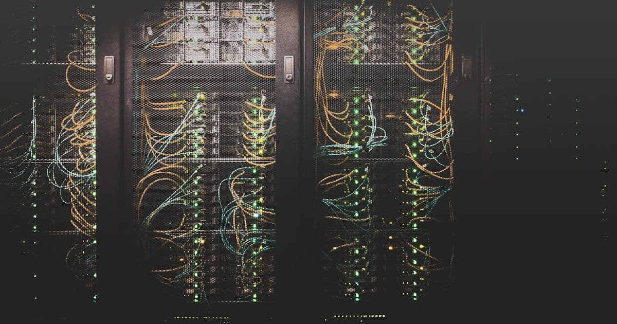 Abstract digital data pathways illuminating a dark server room, representing customer data infrastructure and master data management operations.